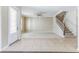Bright open-concept living room with tile floors, staircase, and natural lighting at 7184 Maleberry Run, Winter Garden, FL 34787