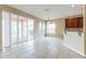 Bright living space with tiled floors, neutral decor, and access to outdoor patio through sliding doors at 7184 Maleberry Run, Winter Garden, FL 34787