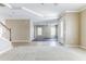 Open-concept living room featuring tile floors, carpeted area, and elegant trim at 7184 Maleberry Run, Winter Garden, FL 34787
