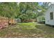 Backyard features a shed, seating area, lush lawn, and wooden fence at 826 Garden Plz, Orlando, FL 32803