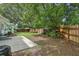 Expansive backyard with lush lawn, tall trees, and a wooden fence for privacy at 826 Garden Plz, Orlando, FL 32803