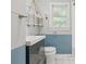 Bathroom featuring blue and white decor, a white sink and a hanging shelf at 826 Garden Plz, Orlando, FL 32803