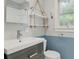 Charming bathroom featuring blue and white decor and a unique hanging shelf at 826 Garden Plz, Orlando, FL 32803