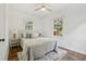 A bright bedroom with dual windows, wood floors, and matching lamps on bedside tables at 826 Garden Plz, Orlando, FL 32803