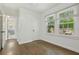 Bright bedroom featuring hardwood floors, a window, and an adjacent bathroom at 826 Garden Plz, Orlando, FL 32803