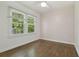 Sun-filled bedroom with hardwood floors, a ceiling fan, and natural light at 826 Garden Plz, Orlando, FL 32803