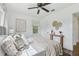 Bright bedroom with a ceiling fan, neutral decor, and natural light streaming through a window at 826 Garden Plz, Orlando, FL 32803