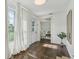 Bright foyer with hardwood floors, white walls, sheer curtains, and views into the living area at 826 Garden Plz, Orlando, FL 32803