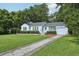 Charming single-story home with a long driveway and mature trees provides inviting curb appeal at 826 Garden Plz, Orlando, FL 32803