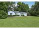 Charming single-story home with a well-manicured lawn and mature trees provides inviting curb appeal at 826 Garden Plz, Orlando, FL 32803