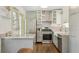 Charming kitchen boasts stainless steel appliances, granite countertops, and modern cabinets, perfect for cooking at 826 Garden Plz, Orlando, FL 32803