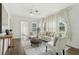 Bright and airy living room featuring hardwood floors, light-colored furniture, and large windows at 826 Garden Plz, Orlando, FL 32803