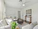 Bright and airy living room featuring hardwood floors, light-colored furniture, and modern art at 826 Garden Plz, Orlando, FL 32803