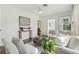 Bright and airy living room featuring hardwood floors, light-colored furniture, and an arched doorway at 826 Garden Plz, Orlando, FL 32803
