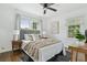 Inviting main bedroom with natural light features wood floors, a ceiling fan, and stylish decor at 826 Garden Plz, Orlando, FL 32803