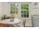 The window view showcases the lush greenery outside, bringing natural light into the cozy breakfast nook at 826 Garden Plz, Orlando, FL 32803