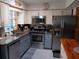 Well-equipped kitchen with granite countertops, stainless steel appliances and two-tone cabinets at 833 Channing Rd, Lakeland, FL 33805