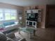Bright living room with hardwood floors, white sofa, and large window at 833 Channing Rd, Lakeland, FL 33805