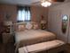 Comfortable main bedroom features a ceiling fan, wood flooring, large windows, and neutral paint at 833 Channing Rd, Lakeland, FL 33805