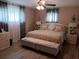 Comfortable main bedroom features a ceiling fan, wood flooring, large windows, and neutral paint at 833 Channing Rd, Lakeland, FL 33805