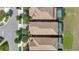 Aerial view of residences featuring beautiful brown rooftops, lush trees, and inviting pools at 8901 Rhodes St, Kissimmee, FL 34747