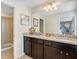 The bathroom boasts granite countertops and a double sink with a walk-in shower at 8901 Rhodes St, Kissimmee, FL 34747