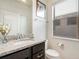 Bathroom featuring a granite vanity top, modern fixtures, and natural light at 8901 Rhodes St, Kissimmee, FL 34747