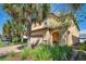 Charming home boasts a two-car garage, lush landscaping, and stone accents at 8901 Rhodes St, Kissimmee, FL 34747