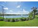 Expansive lake view with fountain, lush green grass and beautiful blue skies at 8901 Rhodes St, Kissimmee, FL 34747