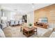 Open-concept living area features stylish furnishings, wood accent wall and plenty of natural light at 8901 Rhodes St, Kissimmee, FL 34747