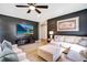 Cozy living room with a modern entertainment center and comfortable seating arrangement at 8901 Rhodes St, Kissimmee, FL 34747