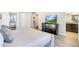 This spacious main bedroom offers an attached bathroom and a large dresser with TV at 8901 Rhodes St, Kissimmee, FL 34747