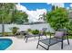 Backyard seating with pool, waterfall feature, and tropical foliage at 912 Pickfair Ter, Lake Mary, FL 32746