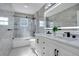 Modern bathroom with dual sinks, stylish gray tile, and a glass-enclosed shower at 912 Pickfair Ter, Lake Mary, FL 32746