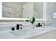 Modern bathroom with double vanity, waterfall faucets, and a lighted mirror at 912 Pickfair Ter, Lake Mary, FL 32746