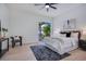 Bright bedroom with a ceiling fan, sliding glass door, and access to a screened-in patio at 912 Pickfair Ter, Lake Mary, FL 32746