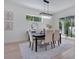 Bright dining room featuring a modern chandelier, table with seating for six, and view to outdoor space at 912 Pickfair Ter, Lake Mary, FL 32746
