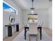 Dining room featuring a modern chandelier, table with seating for six, and contemporary accents at 912 Pickfair Ter, Lake Mary, FL 32746