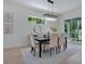Bright dining room featuring a modern chandelier, table with seating for six, and view to outdoor space at 912 Pickfair Ter, Lake Mary, FL 32746