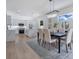 Bright dining room leads to kitchen with island and modern cabinetry at 912 Pickfair Ter, Lake Mary, FL 32746