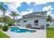 Exterior view of a modern two-story home featuring a pool, well-maintained lawn, and mature landscaping at 912 Pickfair Ter, Lake Mary, FL 32746