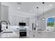 Bright kitchen with stainless steel appliances, white cabinetry, and center island with pendant lighting at 912 Pickfair Ter, Lake Mary, FL 32746