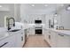Modern kitchen with stainless steel appliances, sleek white cabinets, and ample counter space at 912 Pickfair Ter, Lake Mary, FL 32746