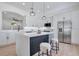 Bright kitchen with white cabinetry, stainless steel appliances, and a stylish island with seating for two at 912 Pickfair Ter, Lake Mary, FL 32746