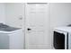 Well-lit laundry room featuring a door, washer and dryer at 912 Pickfair Ter, Lake Mary, FL 32746