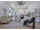 Bright living room featuring modern decor, stylish furniture, and a ceiling fan at 912 Pickfair Ter, Lake Mary, FL 32746