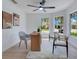 Office space with a ceiling fan, light hardwood floors, a desk, and two windows at 912 Pickfair Ter, Lake Mary, FL 32746