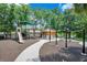 Community playground with slides and other play equipment, surrounded by trees and landscaping at 912 Pickfair Ter, Lake Mary, FL 32746