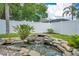 Relaxing backyard rock pond featuring clear water and tropical plants at 912 Pickfair Ter, Lake Mary, FL 32746