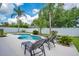 Inviting backyard pool surrounded by lush tropical foliage and lounge chairs at 912 Pickfair Ter, Lake Mary, FL 32746